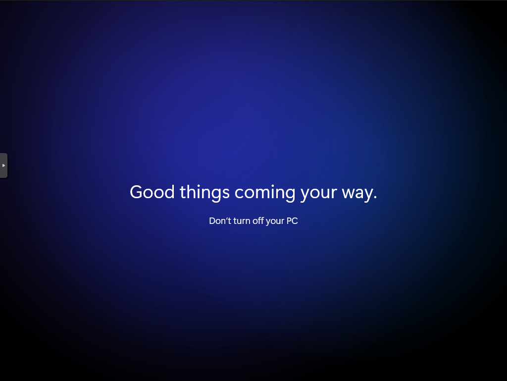 Black screen with a dark blue round spotlight gradient in the center. The text “Good things coming your way. is in white in the center of the screen. The text “Don’t turn off your PC” is in slightly smaller white text centered underneath.