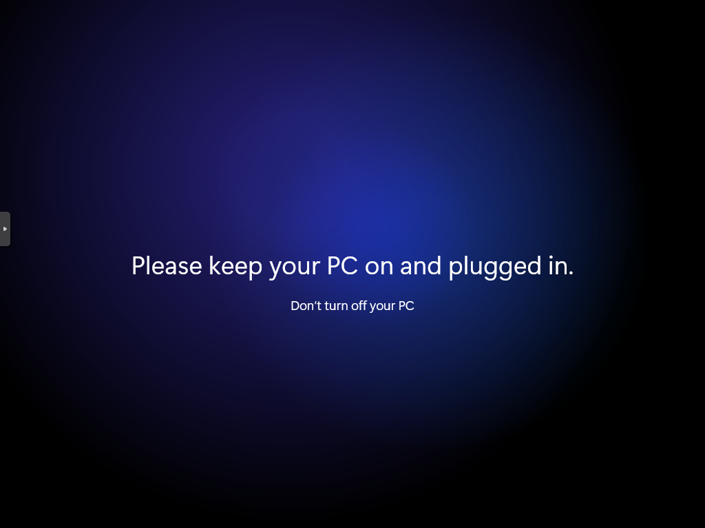 Black screen with a dark blue round spotlight gradient in the center. The text “Please keep your PC on and plugged in.” is centered on the screen in white text. The text “Don’t turn off your PC” is in slightly smaller white text centered underneath.
